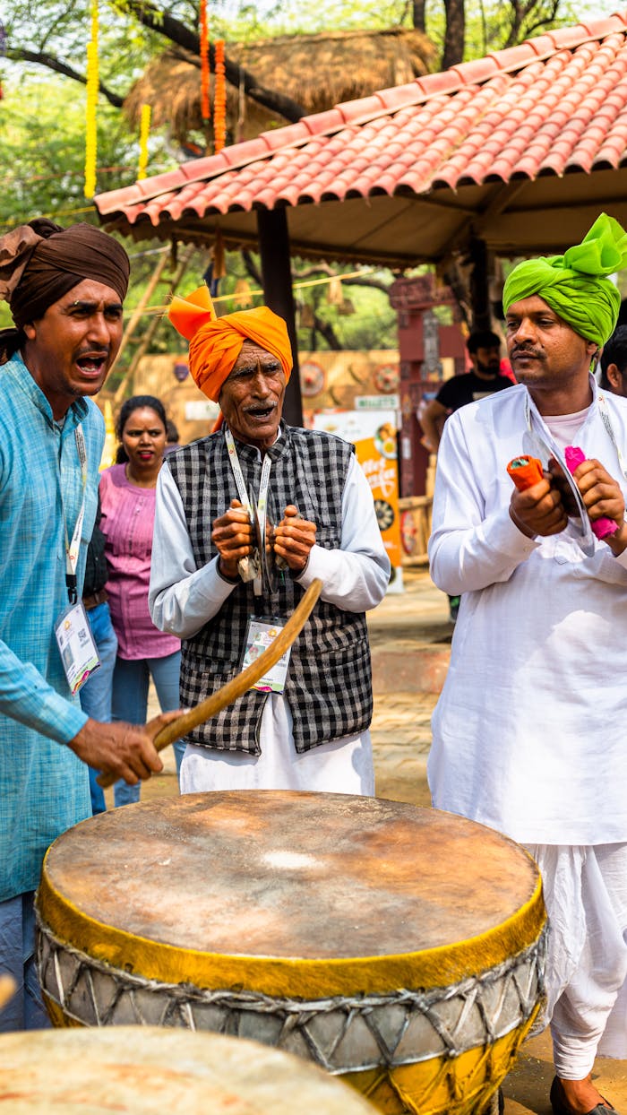 Vibrant outdoor scene of Indian musicians performing with drums and traditional dress.
